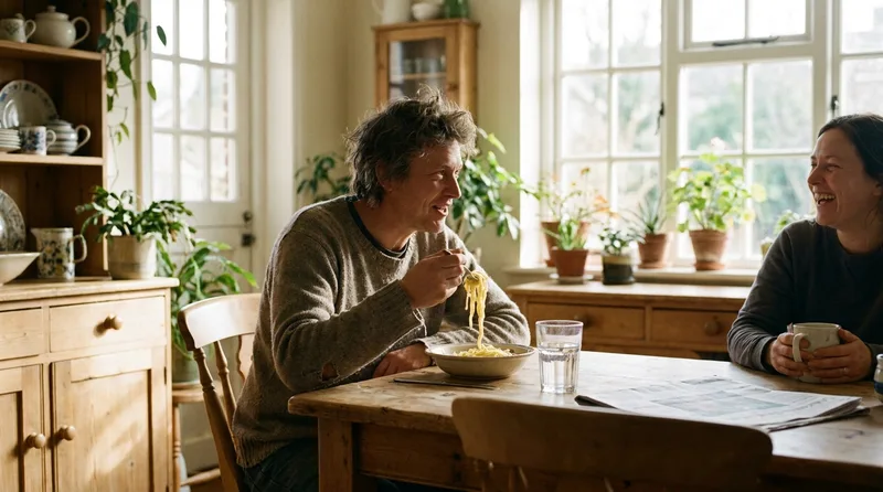 Adult eating soft pasta at home a few weeks into dental implant recovery
