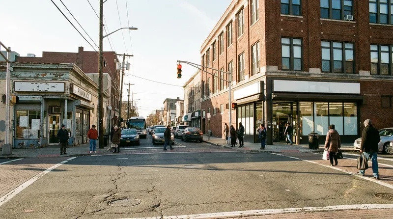 Independent pharmacy and a large corner drugstore facing each other across a busy New Jersey downtown intersection
