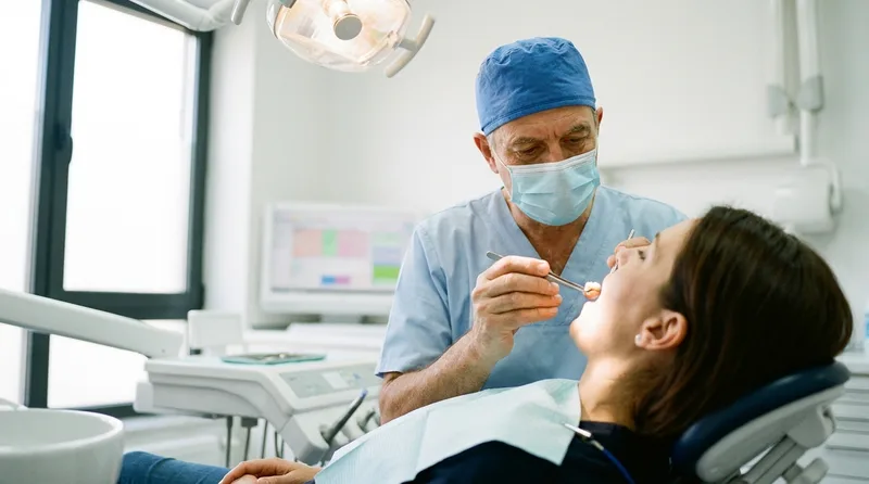 Dentist examining a dental crown during a routine checkup