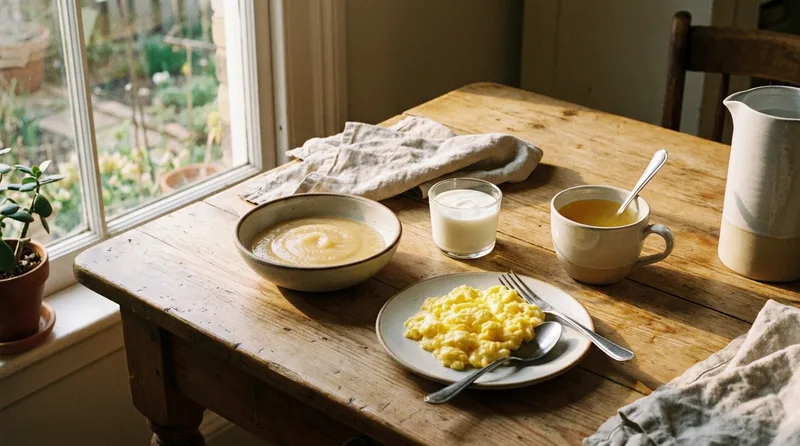 Table with applesauce, yogurt, broth, and scrambled eggs, soft foods for wisdom teeth removal recovery