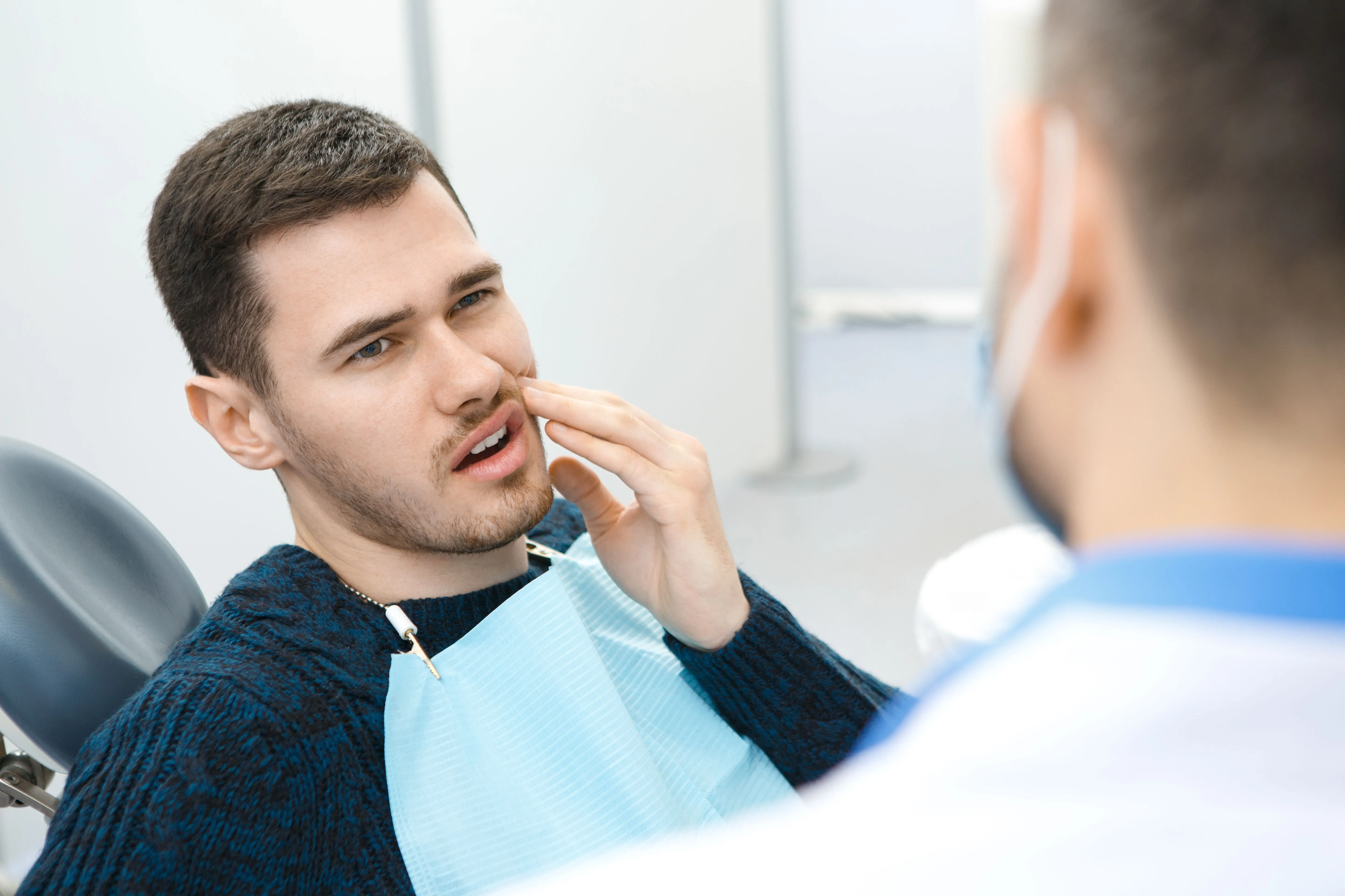 Dentist examining a tooth that may need to be extracted